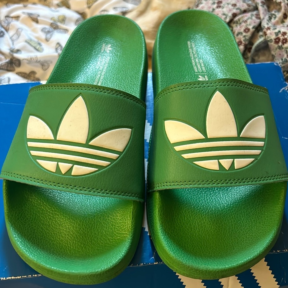 Green adidas foam slippers